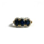 A 14CT GOLD, DIAMOND AND SAPPHIRE THREE STONE RING. (UK ring size K, gross weight 3.9g)