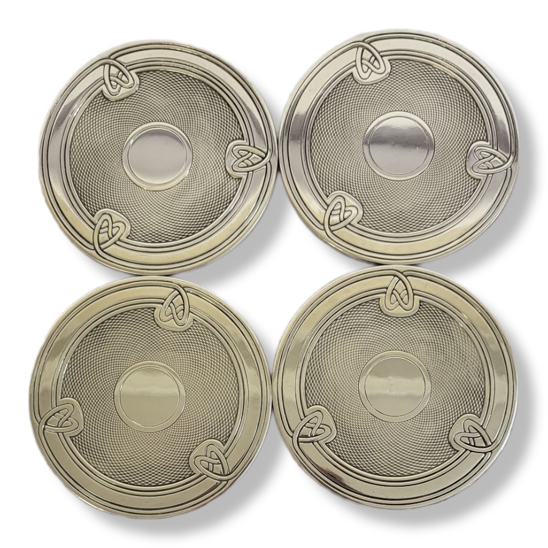 CHRISTOFLE, A SET OF FOUR 20TH CENTURY FRENCH SILVER COASTERS Having a Celtic design to rim and