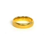 AN EARLY 22CT GOLD WEDDING BAND Having inscribed initials to the interior, dated 1915. (size L)