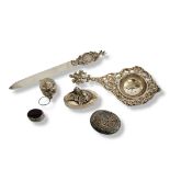 A COLLECTION OF EARLY 20TH CENTURY AND LATER WHITE METAL TRINKETS Comprising a figural strainer with