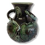 A LATE 19TH CENTURY BRANNAM BARNSTAPLE DEVON GLOBULAR POTTERY VASE With three swirling handles,