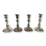 A SET OF FOUR ANTIQUE GEORGIAN DESIGN HALLMARKED SILVER DESK TOP CANDLESTICKS Queen Anne shape,