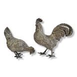 A CONTINENTAL SILVER NOVELTY COCKEREL AND HEN Standing pose, bearing import mark to tail ‘92Y’. (