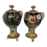 A PAIR OF EARLY 20TH CENTURY JAPANESE SATSUMA JARS AND COVERS Three pierced handles, floral