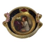 A LATE 19TH CENTURY VIENNA STYLE HARD PASTE PORCELAIN JEWELLED TWIN HANDLED CABINET DISH FORMED AS A
