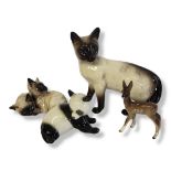 A VINTAGE BESWICK PORCELAIN SIAMESE CAT Together with another Beswick, Siamese cat group, a