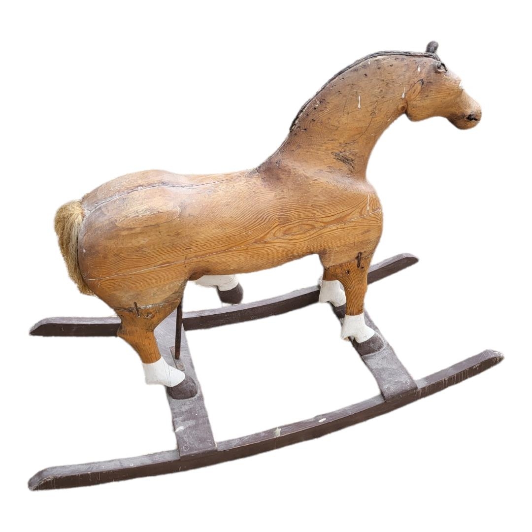 A 19TH CENTURY PINE ROCKING HORSE Partially painted blaze and hoofs. (108cm x 45cm x 80cm)