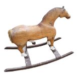 A 19TH CENTURY PINE ROCKING HORSE Partially painted blaze and hoofs. (108cm x 45cm x 80cm)