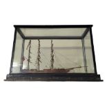 A 19TH CENTURY WOODEN SCALE MODEL, A THREE MASTED SHIP On naturalistic sea in glass case. Condition:
