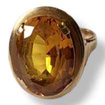 A VINTAGE FRENCH 18CT GOLD AND CITRINE RING The oval citrine in a wide gold mount eagle. (size M/