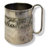 AN INDIAN SILVER CHRISTENING MUG Having an embossed band of exotic animals. (approx 8cm)