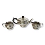 AN EARLY 20TH CENTURY SILVER THREE PIECE TEA SET Comprising a teapot with ebonised finial and