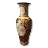 A LARGE ASIAN POTTERY FLOOR STANDING VASE Having a flared neck with embossed scrolled decoration