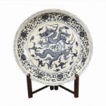 A LARGE CERAMIC CHINESE BLUE AND WHITE CHARGER/PLATE Decorated with a dragon and a Phoenix, together