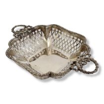 AN EDWARDIAN SILVER SWEETMEAT BASKET Twin classical laurel form handles and pierced decoration,