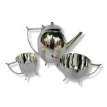 AN ART DECO DESIGN SILVER PLATED THREE PIECE TEA SET Comprising a teapot, milk jug and sugar bowl,