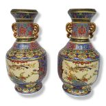 A PAIR OF CHINESE CERAMIC VASES Doubled eared gilded handles with famille rose style polychrome