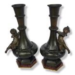 AFTER AUGUESTE MOREAU, A PAIR OF 20TH CENTURY BRONZE CHERUB VASES on a red marble base. (h 27cm)