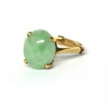 A VINTAGE 9CT GOLD AND JADE RING Oval cabochon cut stone on a plain gold shank. (size L/M)