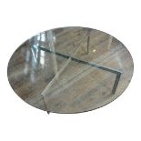 A VINTAGE COFFEE TABLE The heavy circular plate glass top freestanding on chromed metal legs (