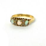 AN EARLY 20TH CENTURY 18CT GOLD OPAL AND DIAMOND RING The row of graduated cabochon cut stones