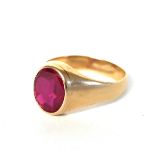 A 14CT GOLD AND RUBY GENT’S SIGNET RING The oval faceted stone in a plain 14ct gold shank. (ruby
