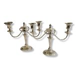 A PAIR OF EDWARDIAN CLASSICAL FORM SILVER CANDELABRA With two branch arms again raised decoration to