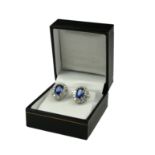 A PAIR OF 18CT WHITE GOLD, OVAL BLUE SAPPHIRE AND DIAMOND CLUSTER STUDS. (BS 4.49CT. DIAMONDS 1.89CT