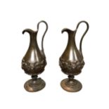 A PAIR OF LATE 19TH CENTURY BRONZE EWERS Having grape and vine decoration. (h 23cm x diameter 8.5cm)