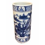 A CHINESE BLUE AND WHITE BRUSH POT Decorated with a landscape scene with figure in a boat, met by