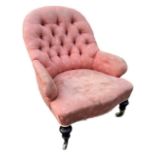 A 19TH CENTURY VICTORIAN UPHOLSTERED NURSING CHAIR Raised on turned mahogany legs terminating on