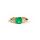 AN 18CT YELLOW GOLD STEP CUT EMERALD AND TRILLIANT CUT DIAMOND THREE STONE RING. (Emerald 1.45ct.