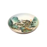 A CHINESE REPUBLICAN FAMILLE VERTE SHALLOW BOWL DECORATED WITH A WATERFALL FIGURAL LANDSCAPE With