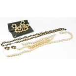 A VINTAGE WHITE METAL AND DIAMOND PEARL NECKLACE The single row of graduated pearls with bow form