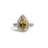 AN 18CT WHITE GOLD PEAR SHAPE GOLDEN BERYL AND DIAMOND CLUSTER RING. (Beryl 1.34ct. Diamonds 0.39ct)