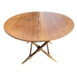 A LATE 19TH CENTURY CIRCULAR MAHOGANY COACHING TABLE The folding top, raised on ring turned legs