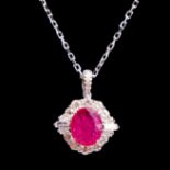 An 18ct white gold, oval ruby and diamond pendant on an 18ct white gold chain. With WGI certificate.