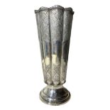 AN IRANIAN/PERSIAN SILVER FLUTED VASE Having chased floral relief to upper and lower body, raised on