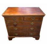 AN 18TH CENTURY GEORGE III MAHOGANY CHEST Of two short over three long graduated drawers flanked