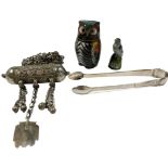 A PAIR OF GEORGIAN SILVER SUGAR TONGS TOGETHER WITH A WHITE METAL BEDOUIN HIRZ PRAYER BOX AMULET AND