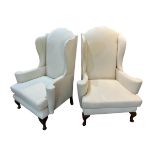 A PAIR OF QUEEN ANN DESIGN WINGBACK Upholstered armchairs, raised on cabriole legs.