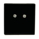 A PAIR OF 18CT WHITE GOLD FOUR CLAW SET ROUND BRILLIANT CUT DIAMOND STUDS, Boxed. (Diamonds 1.03ct)