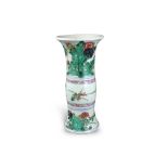 A 'famille verte ' Beaker Vase, Kangxi H:22.5cm with bands of flowers springing from garden rocks to