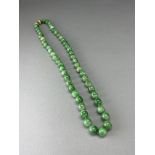 A Jadeite Necklace with gold clasp closed length L:37cm with 54 round beads of mottled green and
