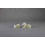 Two small celadon Jade Dogs the larger L: 4cm Carved in Yuan style, both pierced through the back