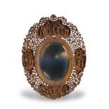 A carved fruitwood Mirror Frame, 19th century H: 38cm of shaped oval form, well carved with four