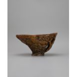 A Good Rhinoceros Horn landscape Libation Cup, 17th/18th century the dark honey coloured body well