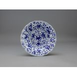 A Blue and White Dish, Kangxi W:20.4cm with fluted rim, decorated with fish, waterplants and a