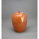 A coral glazed ovoid Jar and Cover, early 20th century H: 32cm overall PROPERTY FROM THE COLIN