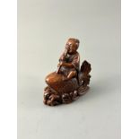A Bamboo Boy and Carp H:9.7cm the boy playing the flute as he rides a giant carp among waves